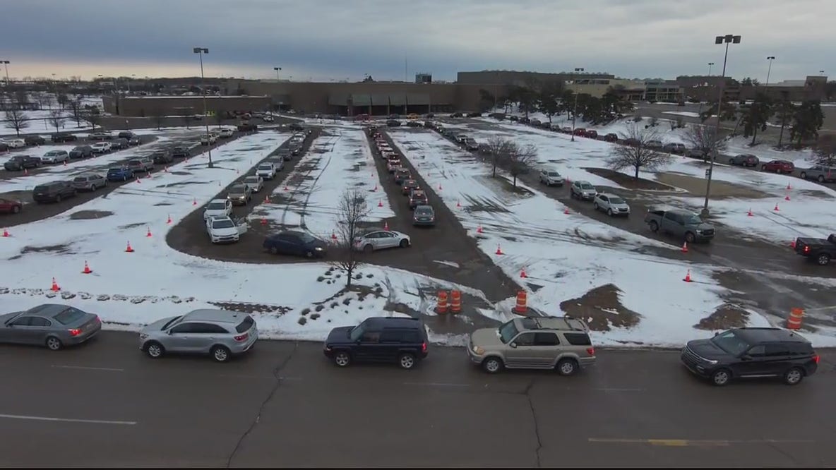 People line up for free COVID-19 testing at Lakeside Mall in Sterling Heights